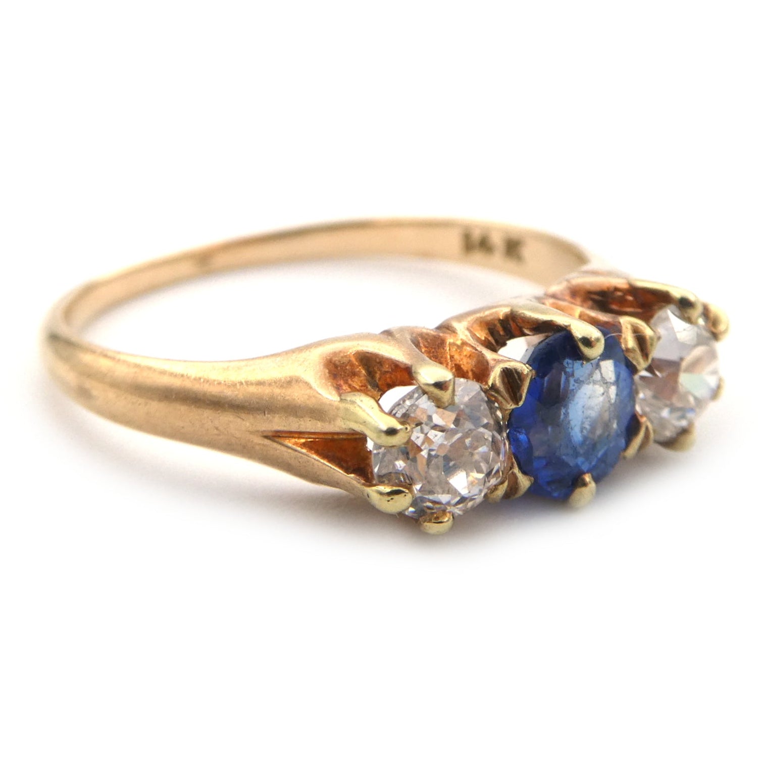 A vintage blue sapphire and diamond three stone ring