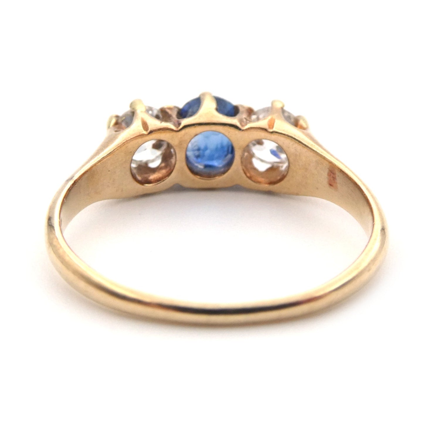 A vintage blue sapphire and diamond three stone ring