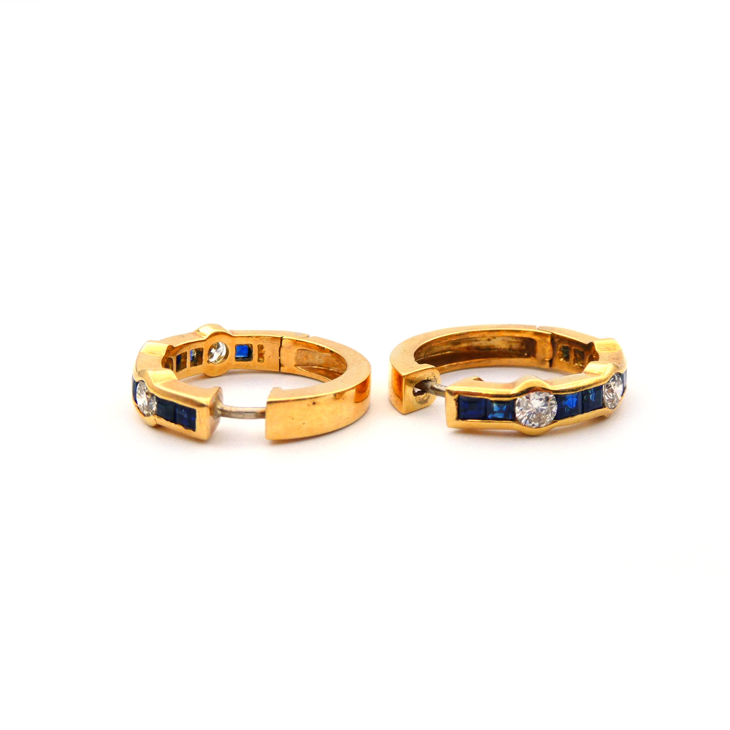 A pair of blue sapphire and diamond hoop earrings