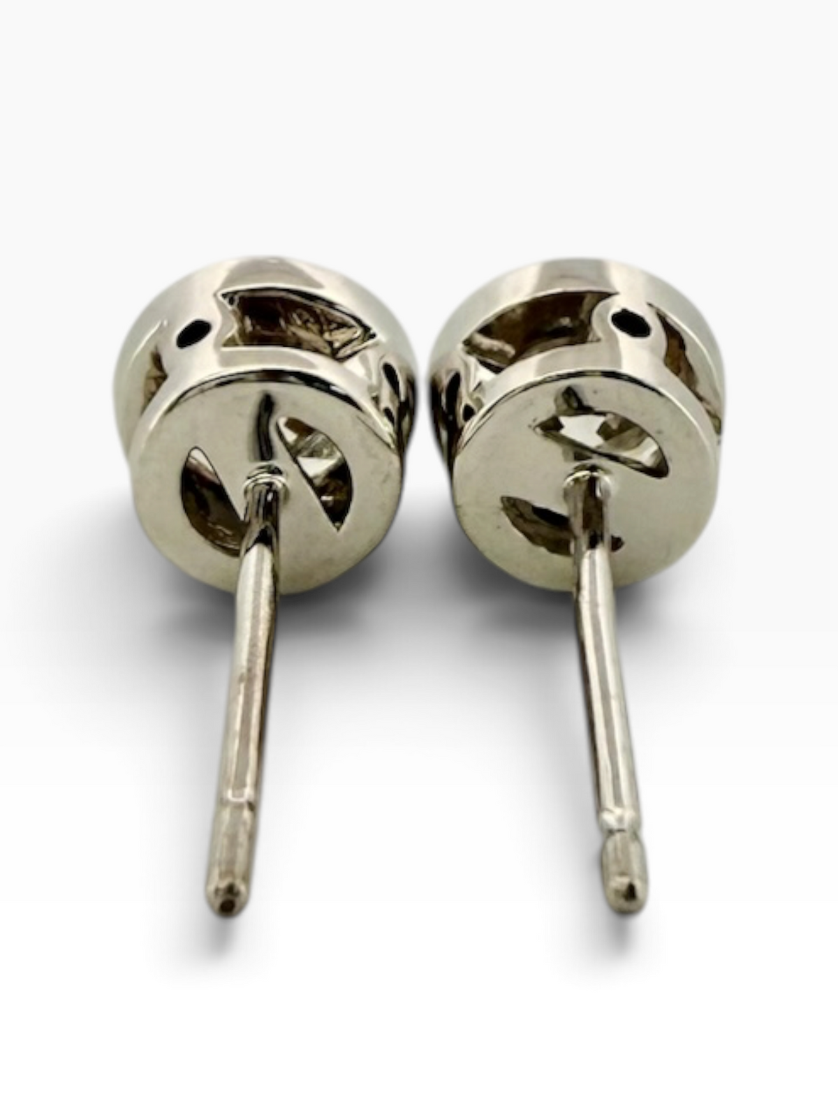 Pair of rub-over set diamond solitaire earrings