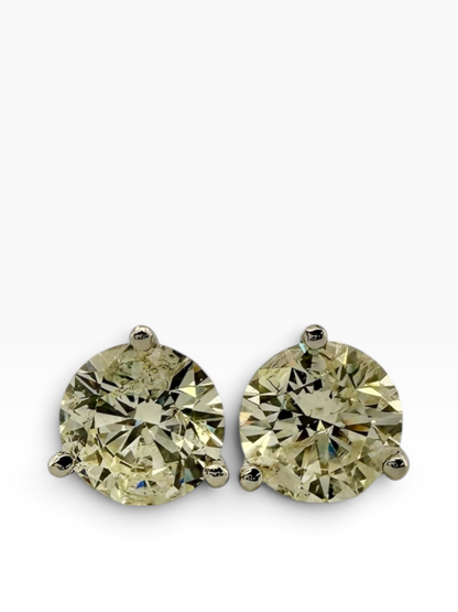 Pair of solitaire diamond earrings