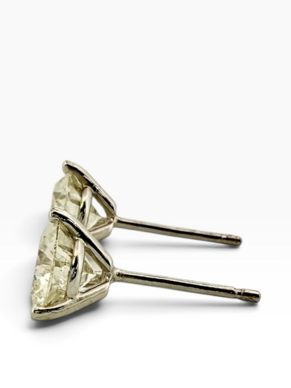 Pair of solitaire diamond earrings