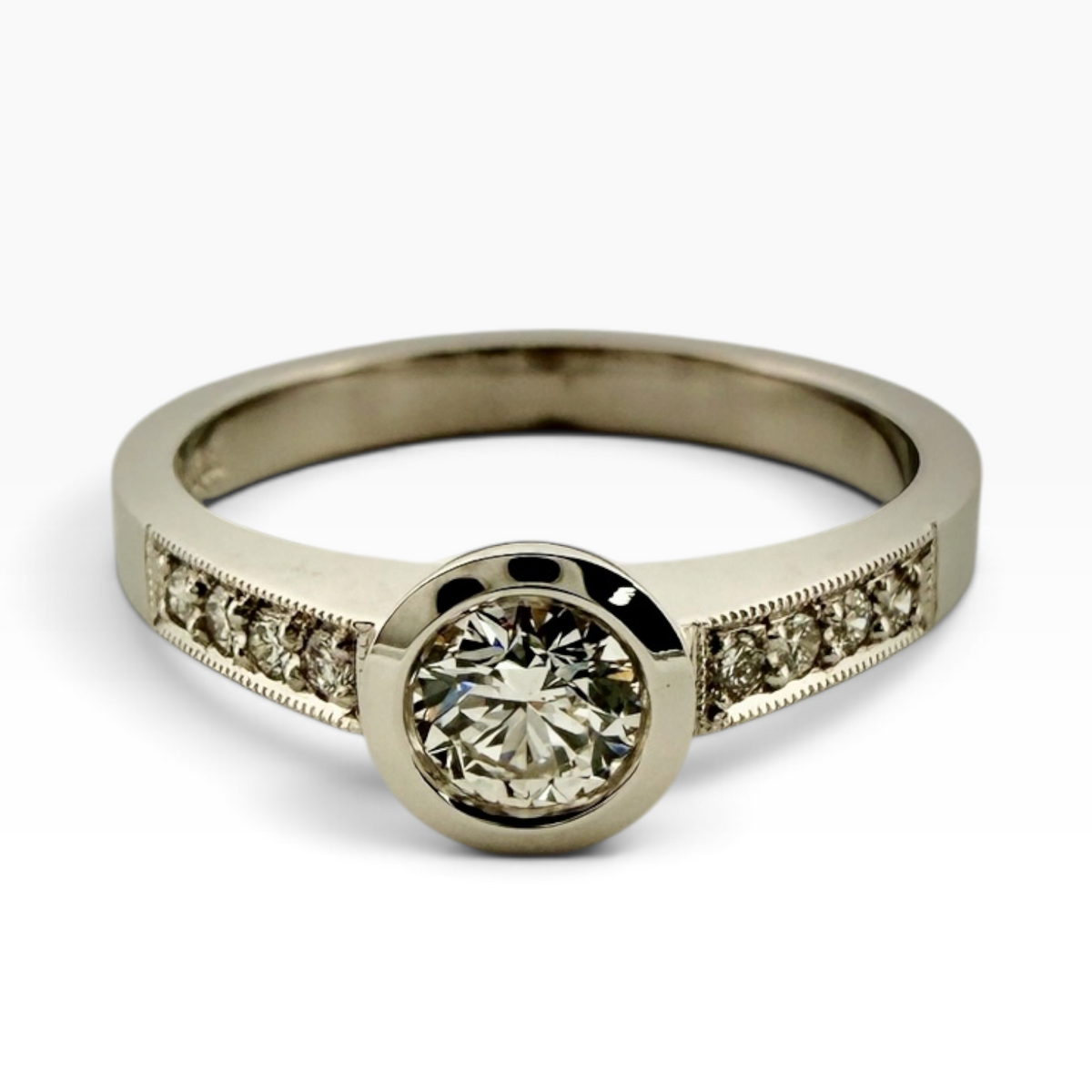 Diamond solitaire ring with accented shoulders