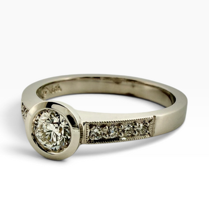 Diamond solitaire ring with accented shoulders