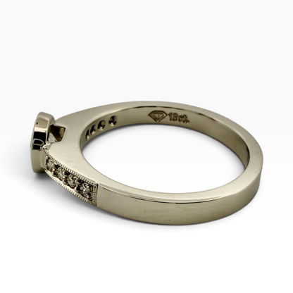 Diamond solitaire ring with accented shoulders
