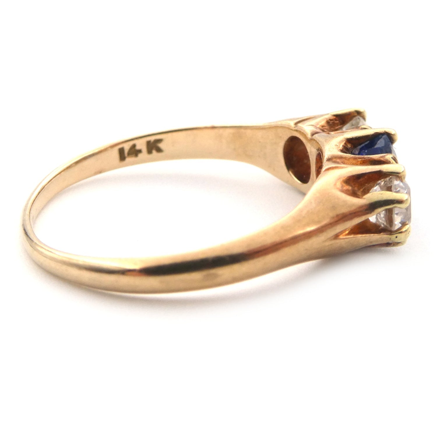 A vintage blue sapphire and diamond three stone ring