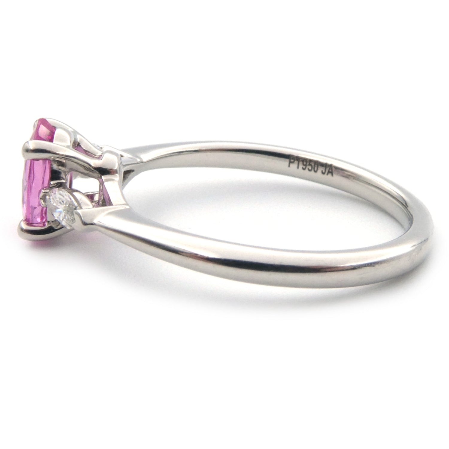 A pink sapphire and diamond three stone ring