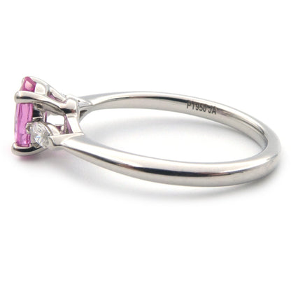 A pink sapphire and diamond three stone ring