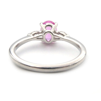 A pink sapphire and diamond three stone ring