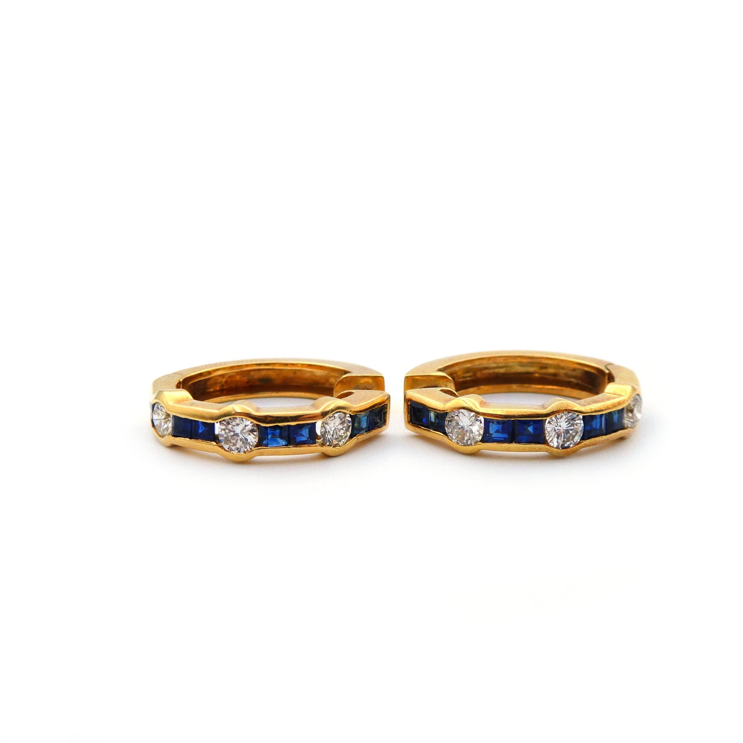 A pair of blue sapphire and diamond hoop earrings