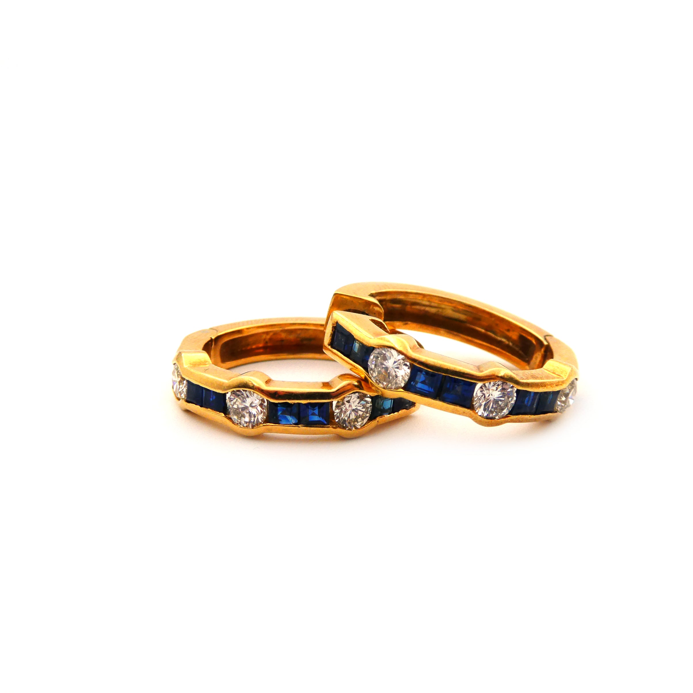 A pair of blue sapphire and diamond hoop earrings