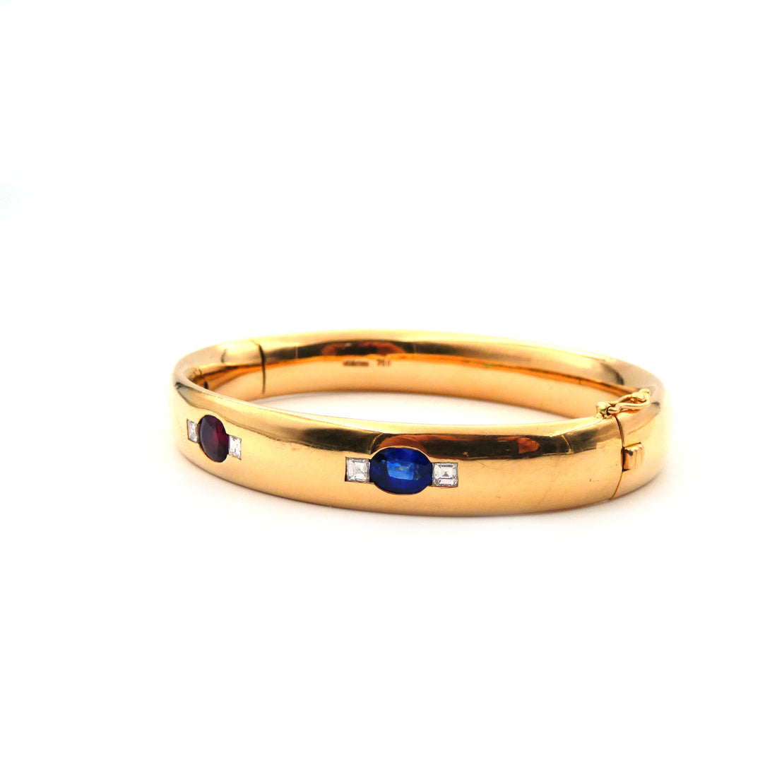 A ruby, sapphire, emerald and diamond hinged bangle