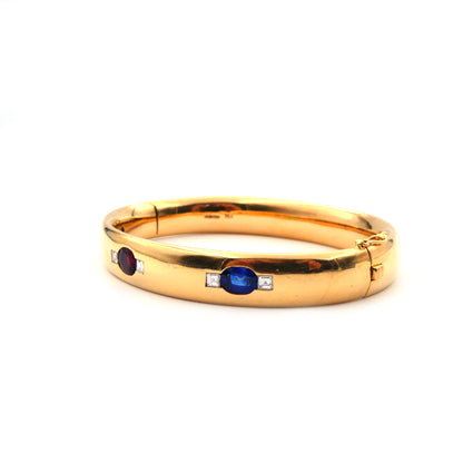 A ruby, sapphire, emerald and diamond hinged bangle