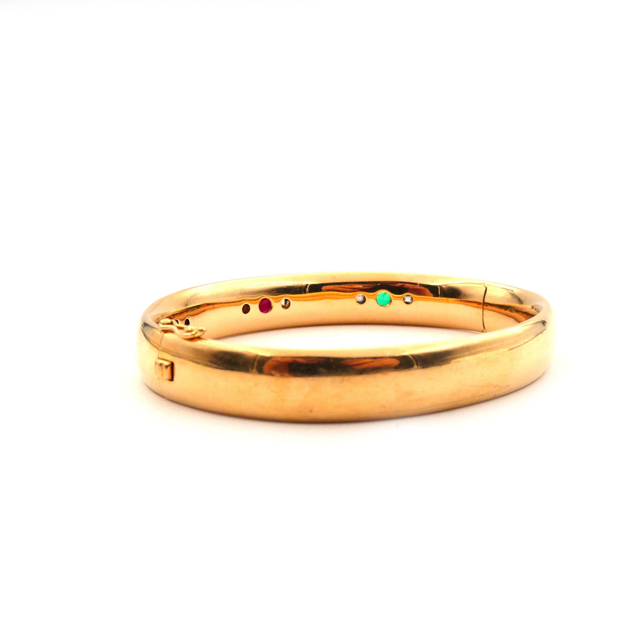 A ruby, sapphire, emerald and diamond hinged bangle