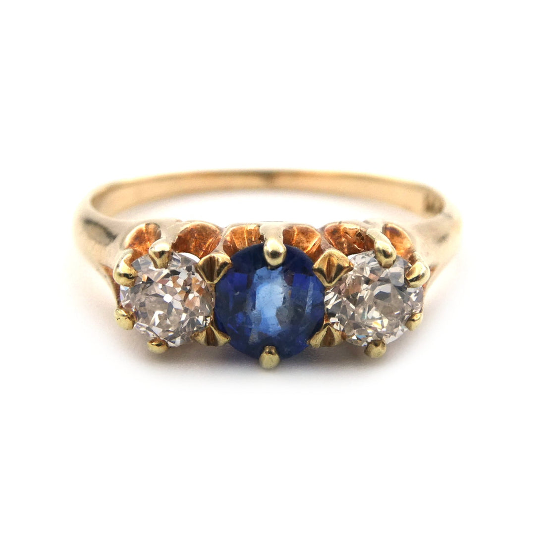 A vintage blue sapphire and diamond three stone ring
